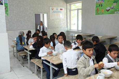 A group of children eating in a classroom  AI-generated content may be incorrect.